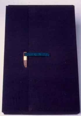 6"X9"X1.50". There were so many notes and memorabilia give to me to add to the book that I decided to include a portfolio to hold everything. The cover is of blue silk over thin book boards. The latch is hand carved walnut inserted into a brass clasp, the tie of a bit of painted silk.